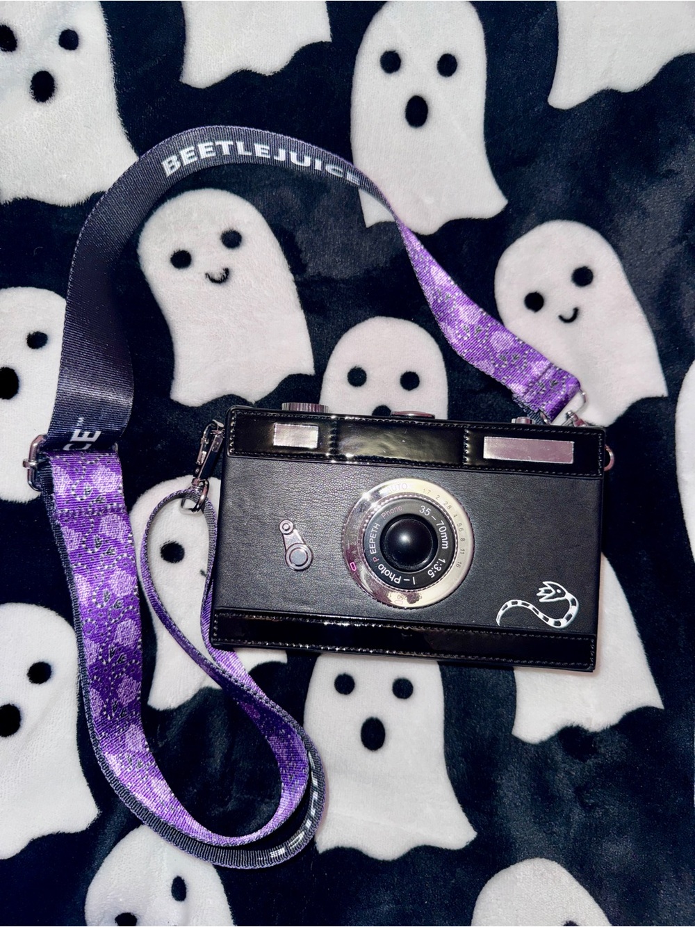 Beetlejuice Camera Crossbody Bag in Black with Purple Strap